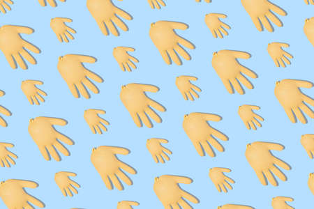 Seamless pattern with inflated yellow medical gloves on a blue background. Prevention and protection of virus. Healthcare concept. Abstract background.の写真素材