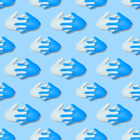 Seamless pattern with inflated medical gloves. A pair of protective gloves with interlocked fingers....