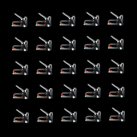 Square pattern of construction staplers on a black background. background for the design.の写真素材