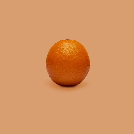 Square shot of orange fruit isolated on orange background.の写真素材