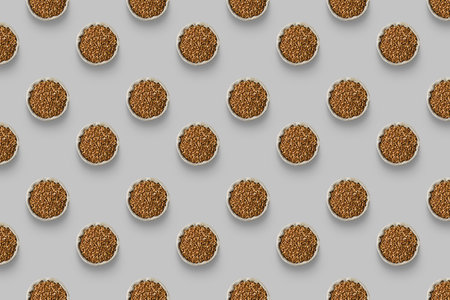 Horizontal pattern of buckwheat bags are isolated on a gray background. top viewの写真素材