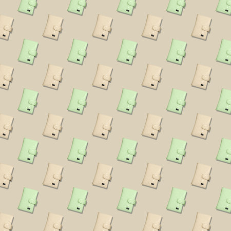 Square seamless pattern of yellow and pistachio women's fashion wallets on a beige background.の写真素材