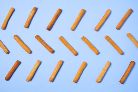 Horizontal seamless pattern of cookie sticks isolated on blue background.の写真素材