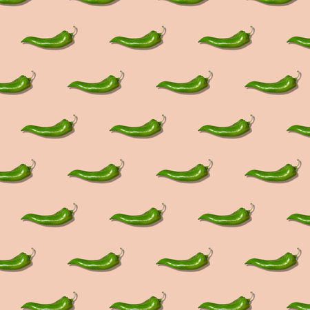 Square seamless pattern of green pepper on pink background. Paprika wallpaper, sweet pepper print pattern.の写真素材