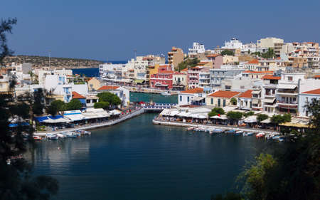 Panorama of Agios Nikolaos (or Ayios, Aghios) town in Crete, Greece. Showing famous places: Lake, Marina, Bay, Old town.の写真素材