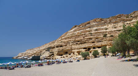 The cliffs at Matala beach, on the south coast of Crete, Greece, which were once Roman-era tombs のeditorial素材