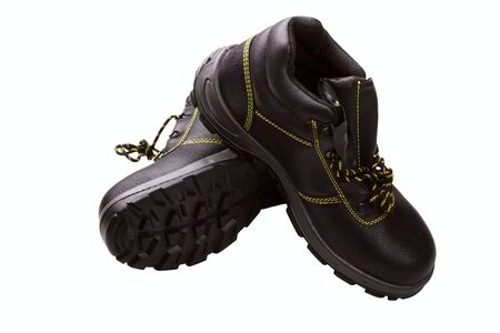 Working boots of black color with a yellow line isolated on a white background