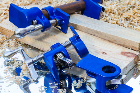 dark blue pipe clamp on sawdust backgroundの写真素材