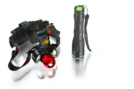 anodized aluminium waterproof tactical flashlight and headlamp on white background