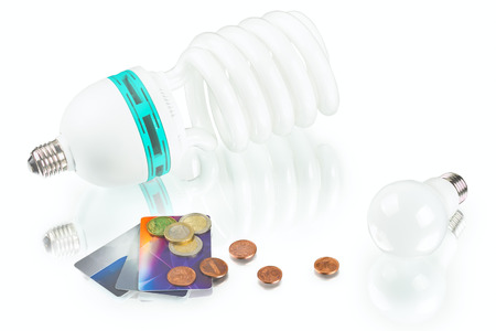 innovation energy-saving LED bulb, spiral lamp and coins on white backgroundの写真素材