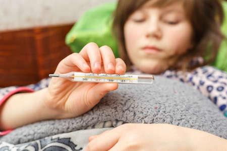child is measured by the temperature of a thermometer, a cold and the flu is at home with a high...