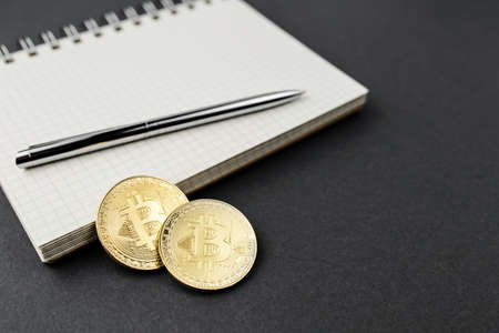 bitcoin on a notebook, coin bitcoin on a table, a lot of free spaceの写真素材