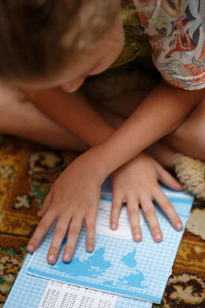child learns the multiplication table, homework, a lesson in mathematics. independent study of...
