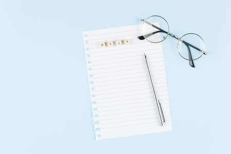 Letters collected the word help on empty sheet on blue background, symbol of helping cancer...