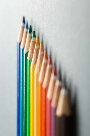 colored pencils in row on a gray background top view. Art set of pencils for schoolboy with free space. view from aboveの写真素材