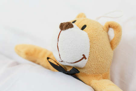 soft toy on the bed, teddy bear on an empty clean children's bed. bed without a childの写真素材