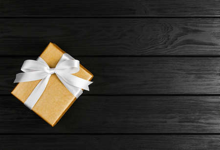 top view of a gift box on a black wooden background, gifts on a black table a flat lay, a festive conceptの写真素材