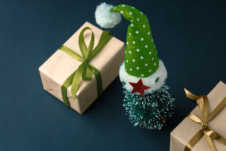 Christmas and New Year background with gifts, deer, stars and fir-trees, flat lay on a dark blue...
