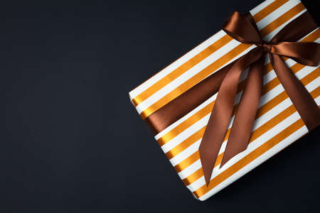 gift on a dark background, top view on a gift box, flat layの写真素材