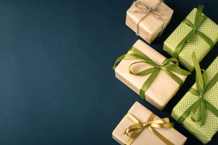 gifts on a dark background lined, top view on a gift box, flat lay
