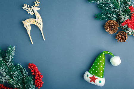 Christmas and New Year background with gifts, deer, stars and fir-trees, flat lay on a dark blue...