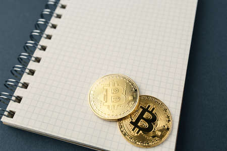 bitcoin on a notebook, coin bitcoin on a table, a lot of free spaceの写真素材