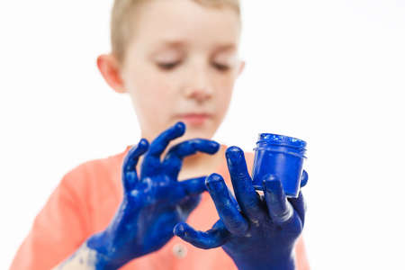 boy paint with hands on the table, drawing lesson at schoolの写真素材