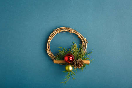 Christmas wreath in the center on a background with a candle and ornaments, Christmas conceptの写真素材