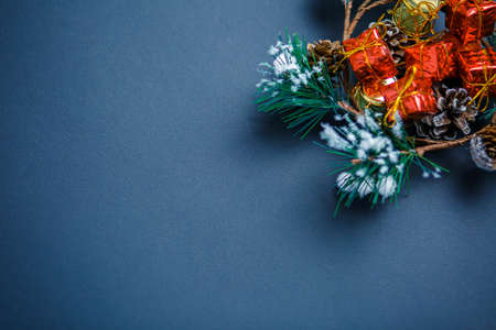 Christmas and New Year background with gifts, deer, stars and fir-trees, flat lay on a dark blue...