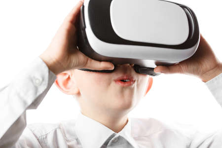 child in virtual reality mask is isolated on white background, boy in shirt plays. vr 360 vision...