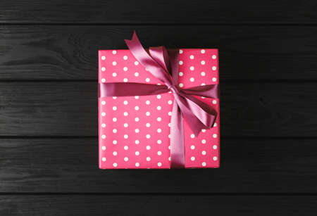 top view of a gift box on a black wooden background, gifts on a black table a flat lay, a festive conceptの写真素材