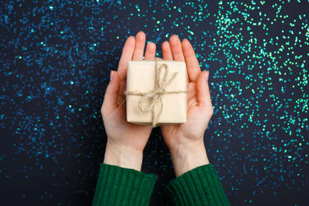 gift on the hands, flat lay on a starry background, holiday greetingsの写真素材
