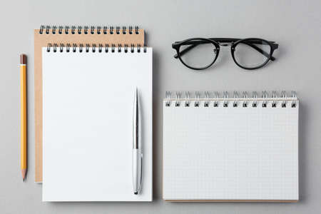 top view of a open notebook with pencil on a gray background, school notebooks with a spiral spring,...