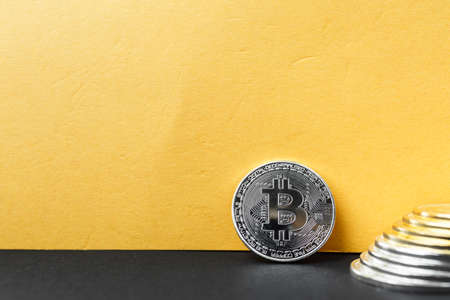 bitcoin yellow background, coin bitcoin on the table, a lot of free space