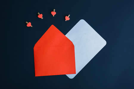 letter with congratulations on a black background with hearts and doves, red envelope concept valentine's dayの写真素材