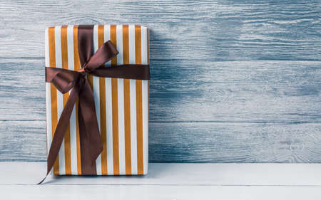 gift box on wooden background top view, flat lay festive conceptの写真素材