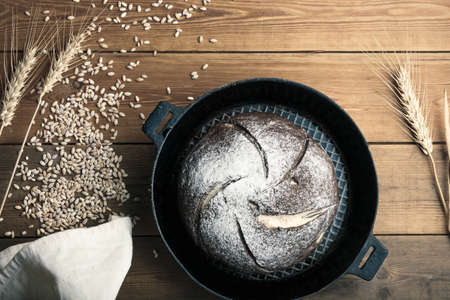 bread on the table, homemade bread with flour and grain on a wooden background