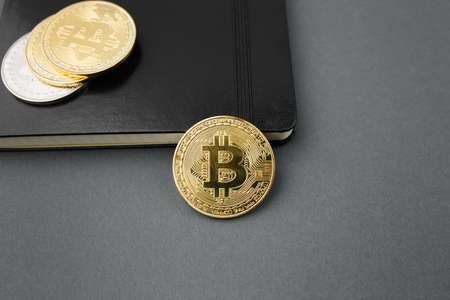 bitcoin on a notebook, coin bitcoin on a table, a lot of free space