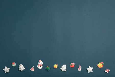 Christmas and New Year background with gifts, deer, stars and fir-trees, flat lay on a dark blue...