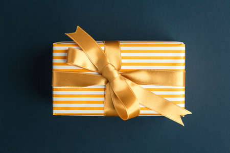 gift on a dark background, top view on a gift box, flat layの写真素材