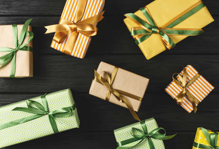 top view of a gift box on a black wooden background, gifts on a black table a flat lay, a festive...