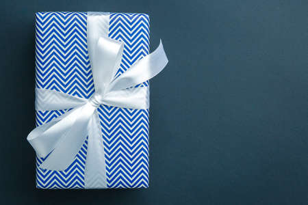 gift on a dark background, top view on a gift box, flat layの写真素材