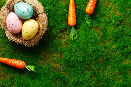 easter composition top view. eggs in the nest on green grass background flat lay with space for text. Congratulatory easter backgroundの写真素材