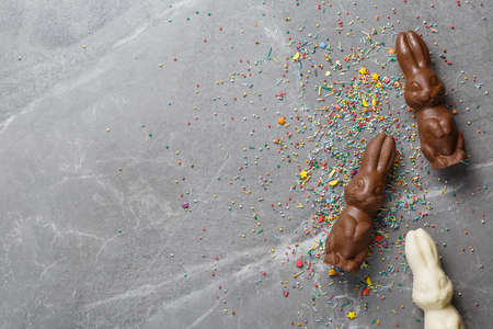 easter composition top view. chocolate bunnies on gray marble background flat lay with space for text. Easter minimal conceptの写真素材