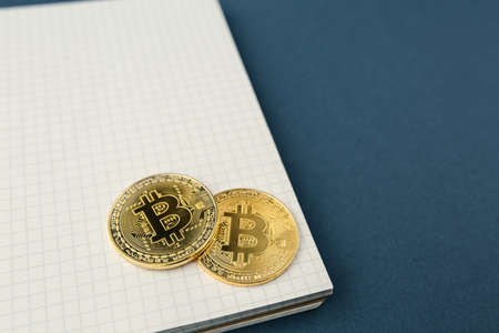 bitcoin on a notebook, coin bitcoin on a table, a lot of free spaceの写真素材