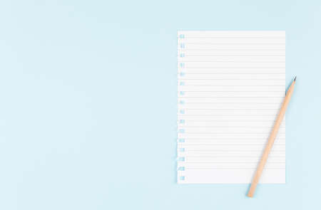 one blank sheet with pencil on blue background top view, spiral notepad blank empty sheet. flat lay...