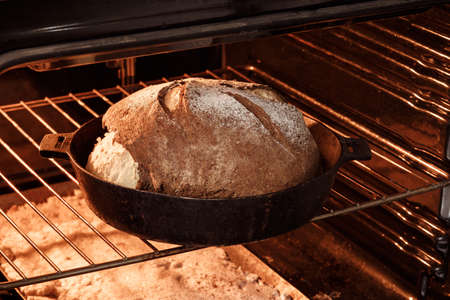 bread on the table, homemade bread with flour and grain on a wooden backgroundの写真素材