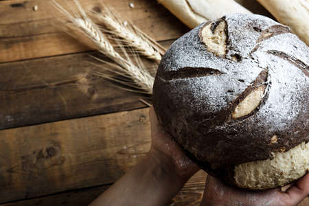 bread on the table, homemade bread with flour and grain on a wooden backgroundの写真素材