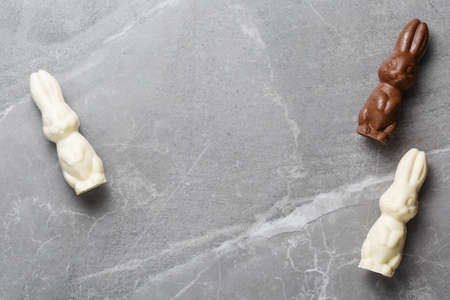 easter composition top view. chocolate bunnies on gray marble background flat lay with space for...