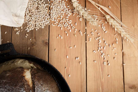 bread on the table, homemade bread with flour and grain on a wooden backgroundの写真素材
